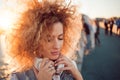 Trendy girl with large headphones on a city walk, close up. Royalty Free Stock Photo