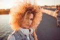 Trendy girl with large headphones on a city walk, close up Royalty Free Stock Photo