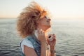 Trendy girl with large headphones and sunglasses on a city walk, close up. Royalty Free Stock Photo