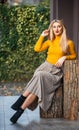 Trendy girl wear corrugated skirt. pleated skirt collection. woman warm autumn skirt sit outdoor. relax while walking