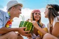 Trendy group of friends drinking cocktails at party. Young people having fun on luxury resort. Royalty Free Stock Photo