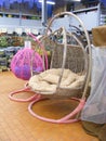 Trendy hanging armchair, swing round armchair in shop