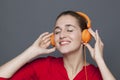 Trendy headphones concept for joyful 20s girl