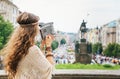 Trendy hippie woman tourist with vintage retro camera in Prague Royalty Free Stock Photo