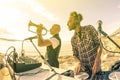 Trendy hipster dj playing summer hits at sunset beach party Royalty Free Stock Photo