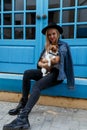 Trendy Hipster blonde Girl with her Dog on Urban Background. Modern Youth Lifestyle Concept Royalty Free Stock Photo