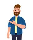 Trendy hipster young man pointing hand to copy space. Stylish bearded person showing or presenting hand gesture sign towards side