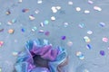 Trendy holographic scrunchie and confetti on blue