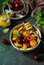 Trendy home breakfast. Mini pancakes, honey and cherries Royalty Free Stock Photo