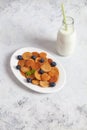 Trendy homemade breakfast, pancake cereal, mini pancakes on white plate on white concrete background with spoon and blueberry, Royalty Free Stock Photo