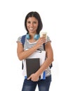 Trendy latin student girl holding notepad folder and book carrying backpack smiling happy Royalty Free Stock Photo