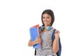 Trendy latin student girl holding notepad folder and book carrying backpack smiling happy Royalty Free Stock Photo