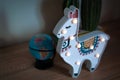 A trendy llama kids night lamp standing on a bedside in dawn or sunrise light