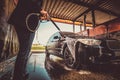 Trendy man in jeans and blaser is washing his own car at car washing station. Royalty Free Stock Photo