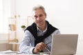 Trendy mature man working on laptop at home Royalty Free Stock Photo