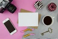 Trendy mockup with mobile phone, blank paper sheet on kraft envelope, cap of coffee, retro photo camera and sweets