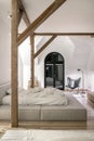 Stylish bedroom in modern style with wooden beams Royalty Free Stock Photo