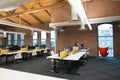 Trendy modern open concept loft office space with big windows, natural light and a layout to encourage collaboration Royalty Free Stock Photo