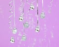 Trendy pastel christmas background. Silver ball Ornaments hanging on sparkling ultraviolet background. minimal christmas concept.