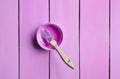 Trendy pastel colors. A paintbrush and a paint jar on a purple wooden background. Top view. Flat lay. Copy space