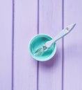 Trendy pastel colors. A paintbrush and a paint jar on a purple wooden background. Top view. Flat lay. Copy space