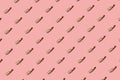Trendy pattern made with lipsticks on bright light pink background. Mua and girly creative concepts. Minimal style with colorful p