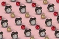 Trendy pattern made with  retro alarm clock and Christmas bauble ball on  pastel pink background Royalty Free Stock Photo