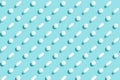 Trendy pattern with medical pills on light blue background, copy space. Medicine creative concept. Minimal style. Top view. Royalty Free Stock Photo