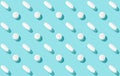 Trendy pattern with medical pills on light blue background, copy space. Medicine creative concept. Minimal style. Top view. Royalty Free Stock Photo