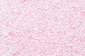 Trendy pattern of white sprinkles over pink background, decoration for donut glaze background