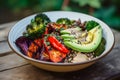 Plant-based bowl with quinoa, roasted vegetables and avocado