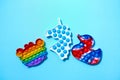 Trendy pop it and simpl dimple toys in form of crab, duck, and unicorn on blue background