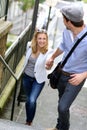 Trendy romantic young couple climbing stairs