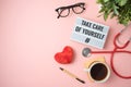 Trendy self care concept with light box, heart shape and stethoscope on pink background Royalty Free Stock Photo