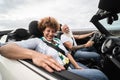 Trendy senior couple having fun in convertible car during summer vacation - Focus on woman face Royalty Free Stock Photo