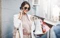 Trendy, stylish and fashionable woman shopping, purchasing and buying clothes in city, town and downtown. Elegant lady Royalty Free Stock Photo