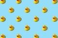 Trendy summer pattern with yellow rubber duck on bright blue background. Minimal summer concept