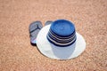 Trendy sunhat and beach thongs on the sand Royalty Free Stock Photo