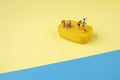 Trendy sunlight Summer scene made with miniature people on bright light blue and yellow background