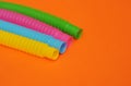 Trendy toys pop tube on orange background