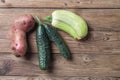 Trendy ugly organic natural potato, cucumber and squash on natural wooden background. Copy space