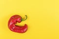 Trendy Ugly red chilli peppers on yellow background, minimal nature style, pop-art, creative food concept