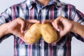 Trendy ugly vegetable human lungs shaped potato in hands Royalty Free Stock Photo