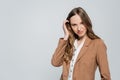 trendy woman in pastel brown blazer