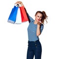 Trendy woman with shopping bags on white blowing air kiss Royalty Free Stock Photo