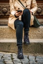 Trendy woman sitting on stairs and using smart phone in city Royalty Free Stock Photo