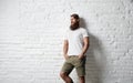 Trendy young bearded man against white brick wall Royalty Free Stock Photo