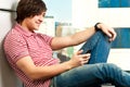 Trendy young guy typing a message Royalty Free Stock Photo