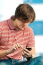 Trendy young guy typing a message on mobile Royalty Free Stock Photo