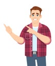 Trendy young man pointing finger to copy space. Stylish happy person introducing or advertising with hand gesture sign. Royalty Free Stock Photo